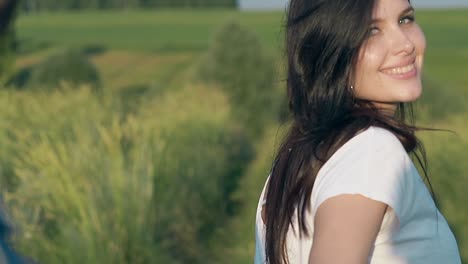 closeup young woman with loose flowing hair turns head