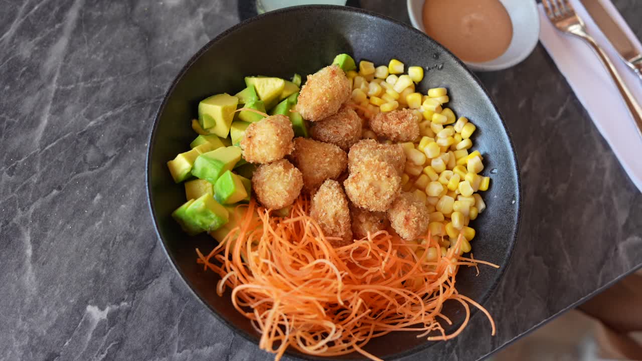 Crispy Chicken Bowl With Avocado and Corn. Close Up