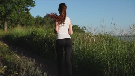 woman running through a park