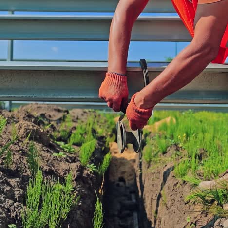 engineering works. worker attaches special equipment during construction. technician works outdoors. slow motion.