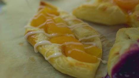 a person decorating sweet danish pastries