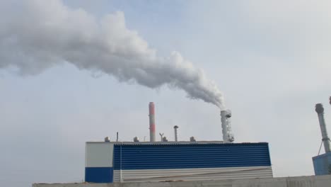 pan over industry chimneys bellowing smoke through the stack