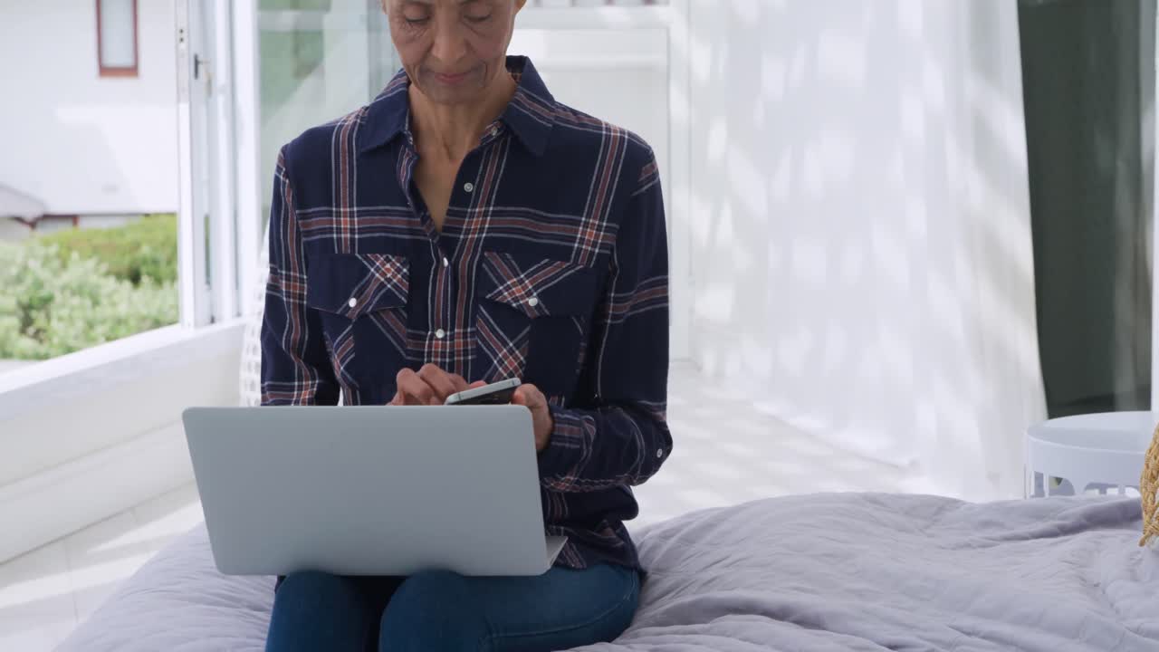Mature woman using technology at home
