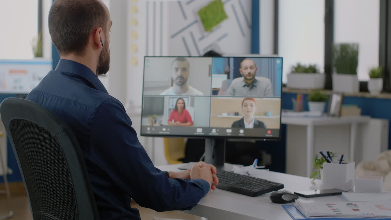 Businessman talking to team of colleagues on video call