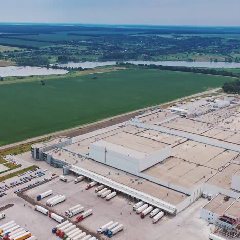 aerial footage of a large industrial complex with car parking place and great perspective of city