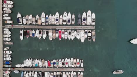 top down flyover of orderly boats moored at marina in budva montenegro