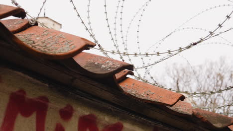 barbwire or nato-fence shielding off a wall