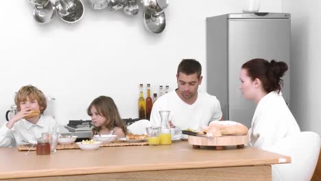 family at home together eating breakfast