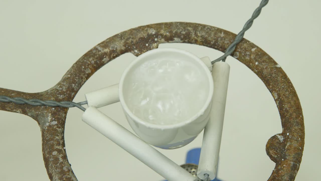 boiling salt water in a crucible to extract the salt during a chemical experiment