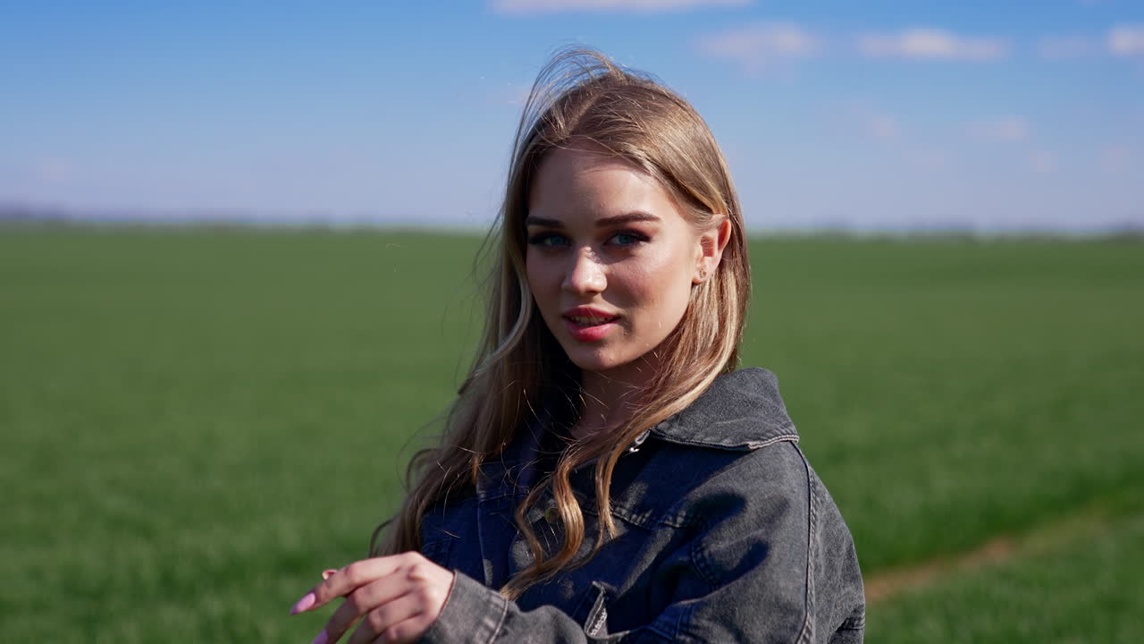 Portrait of attractive young woman outdoors. Pretty model in the countryside. Beautiful village girl posing on camera on nature background.