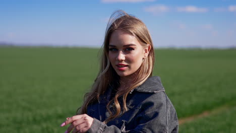 portrait of attractive young woman outdoors. pretty model in the countryside. beautiful village girl posing on camera on nature background.