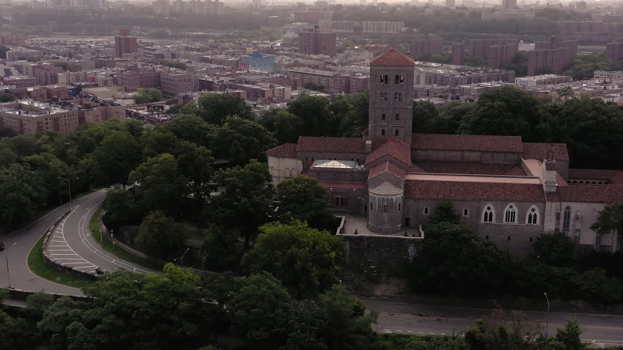 salida rápida de la órbita aérea alrededor del museo cloisters en upper manhattan, nueva york, con el barrio de inwood en la distancia en una mañana brumosa.