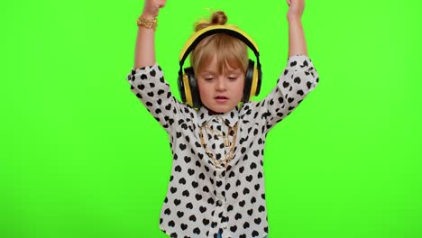 Attractive-blonde-child-kid-listening-music-via-headphones-dancing-disco-fooling-having-fun-party