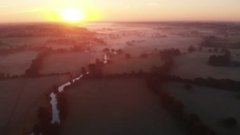 Aerial-footage-of-low-lying-mist-lying-in-the-East-Anglian-countryside-at-sunrise