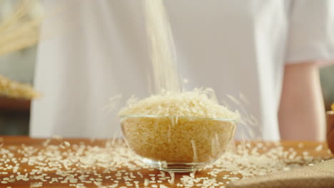 pouring rice into a glass bowl