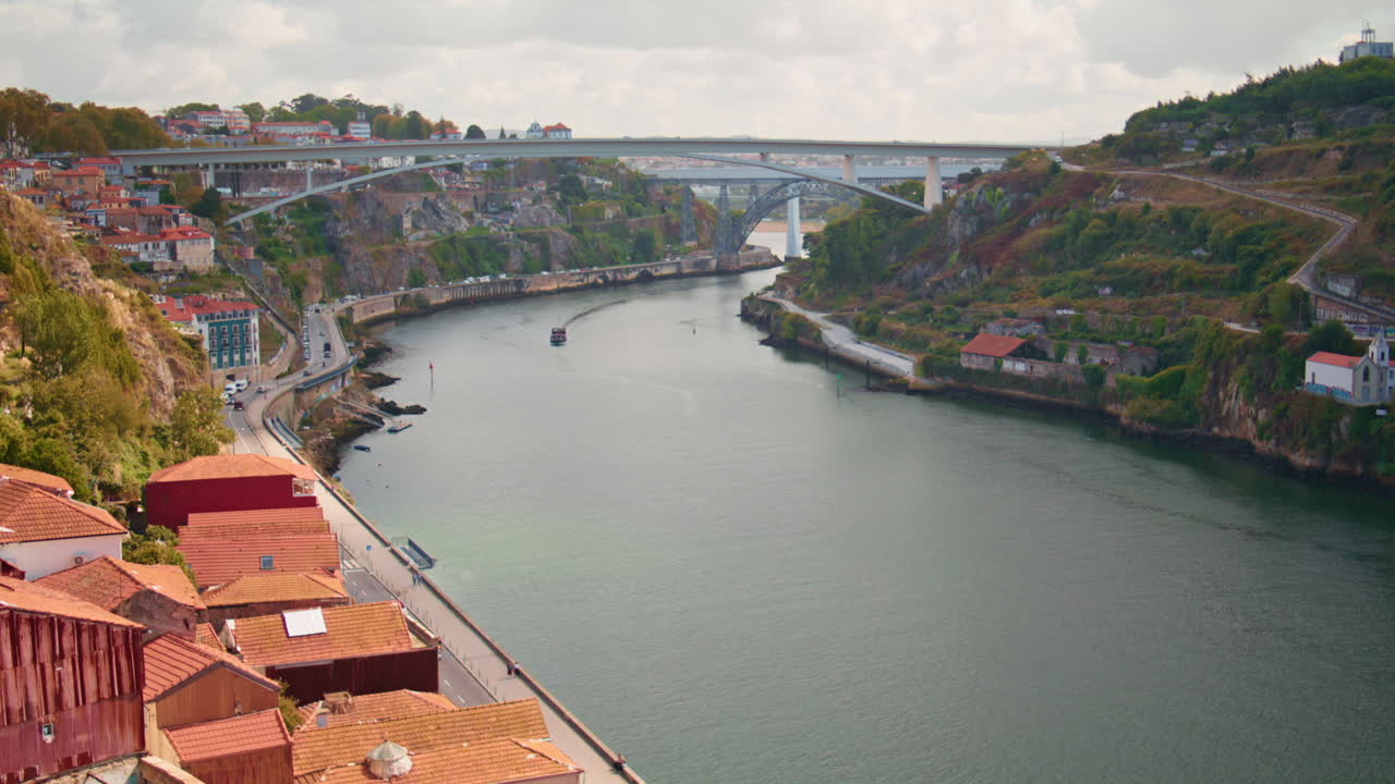 River bridge view cityscape at summer. South red roofs houses on greenery hills