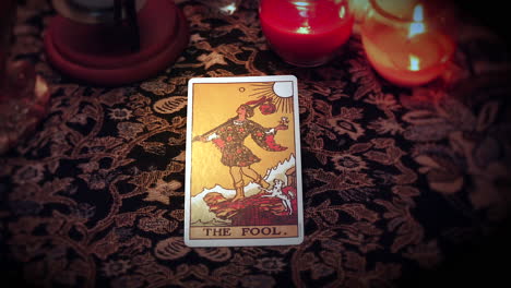 a mystical fortune teller selects a tarot card and places it on the enchanted table