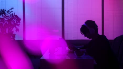 woman working late at night with headphones