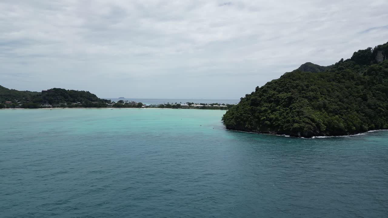 A slow and steady aerial tracking shot capturing the stunning beauty near Monkey Beach, Koh Phi Phi, Thailand.