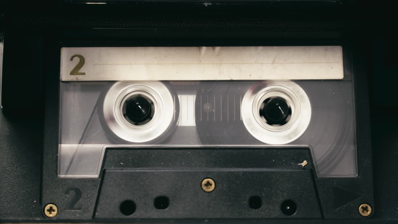 Tape recorder cassette rewind action, stops then plays media CLOSE-UP