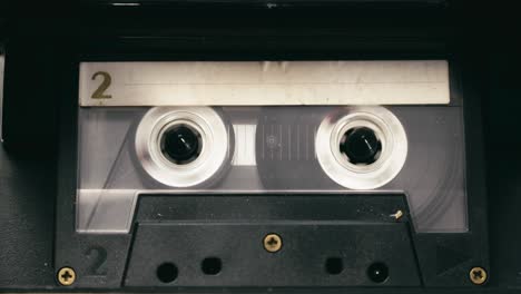 tape recorder cassette rewind action, stops then plays media close-up