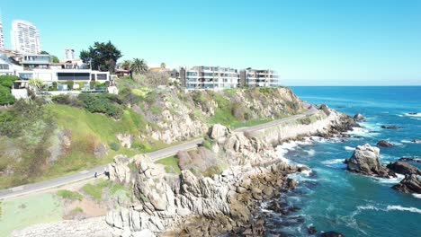 Sunny-Day-on-the-Coast-and-an-Coastal-Road-with-cars-passing-by,-Viña-del-Mar,-Chile