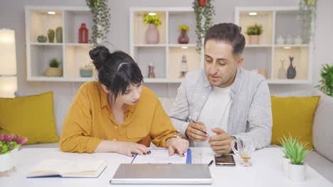 man and woman examine the document after signing it.