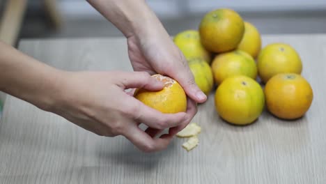 sequential frames of peeling an orange