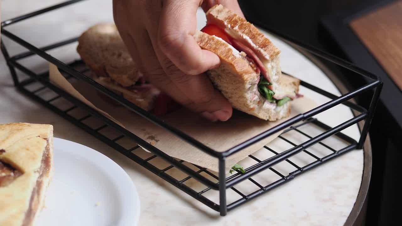 Mano che prende un panino fresco da un cestino