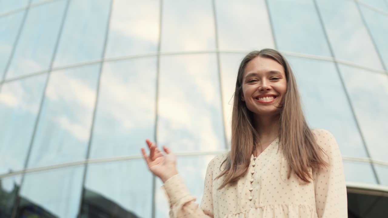 Woman Standing by Glass Building