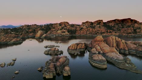 gimbal-footage-of-lake-with-interesting-rock-formations-around-a-lake-with-a-full-moon