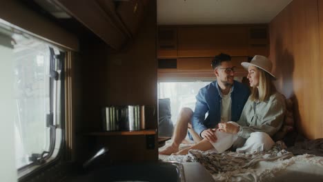 couple relaxing in rv interior