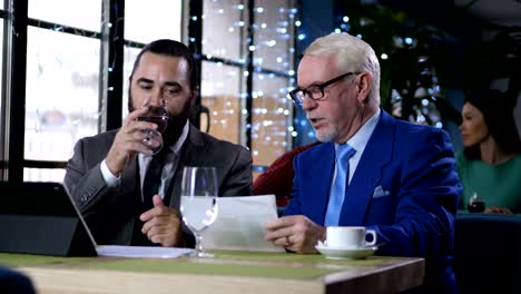 Partners discussing business issues in coffee shop