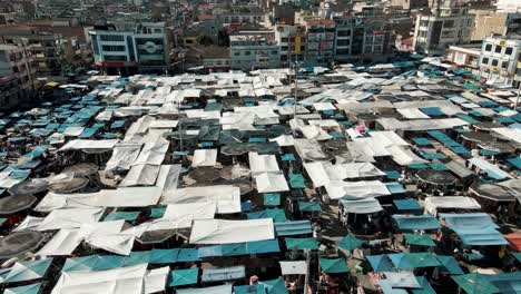 City-Of-Otavalo-With-Its-Plaza-de-Ponchos-In-Ecuador---aerial-drone-shot