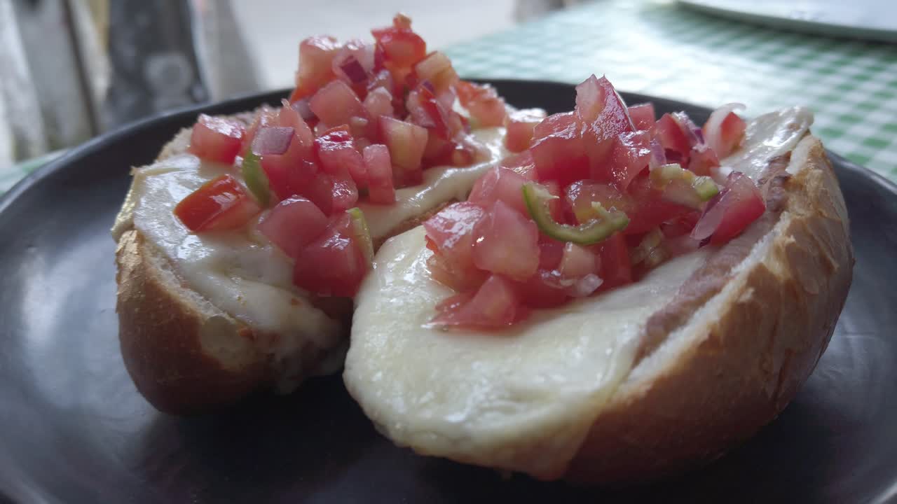 Molletes with melted cheese and fresh salsa on toasted bread