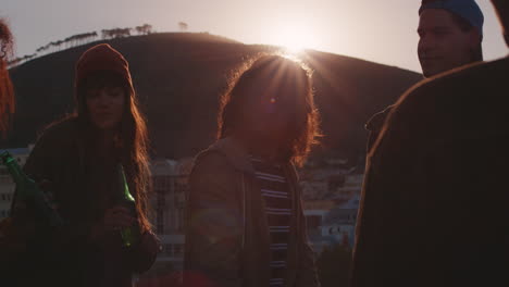 happy-group-of-friends-celebrating-on-rooftop-making-toast-drinking-having-fun-together-enjoying-celebrating-summer-vacation-at-sunset