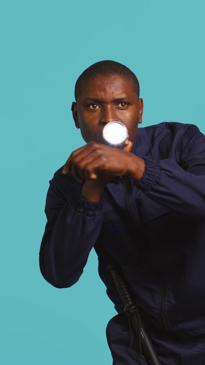 African American Security Guard Searching with Flashlight