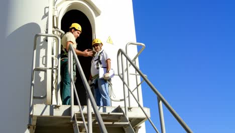 two male engineer using digital tablet in the wind farm 4k