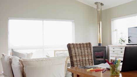 General-view-of-living-room-with-sofa-and-table-with-laptop,-slow-motion