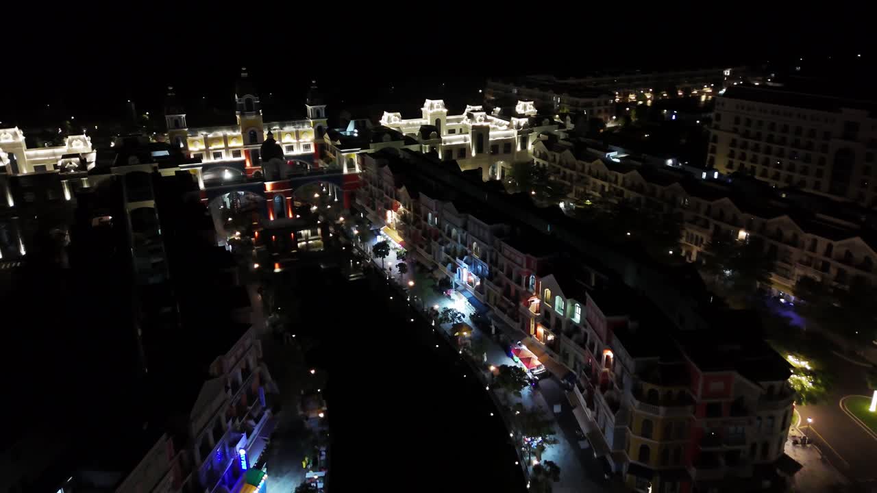 Nighttime close aerial footage reveals Grand World, its trees transformed into radiant displays of colorful lights