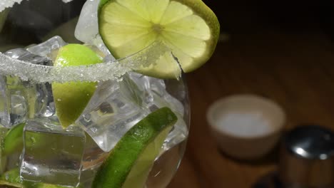 glass of ice, fresh crushed mint and lime waiting on liquid