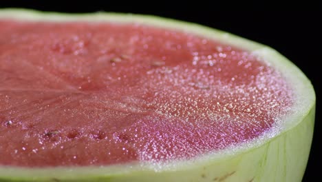 watermelon gyrating on black background