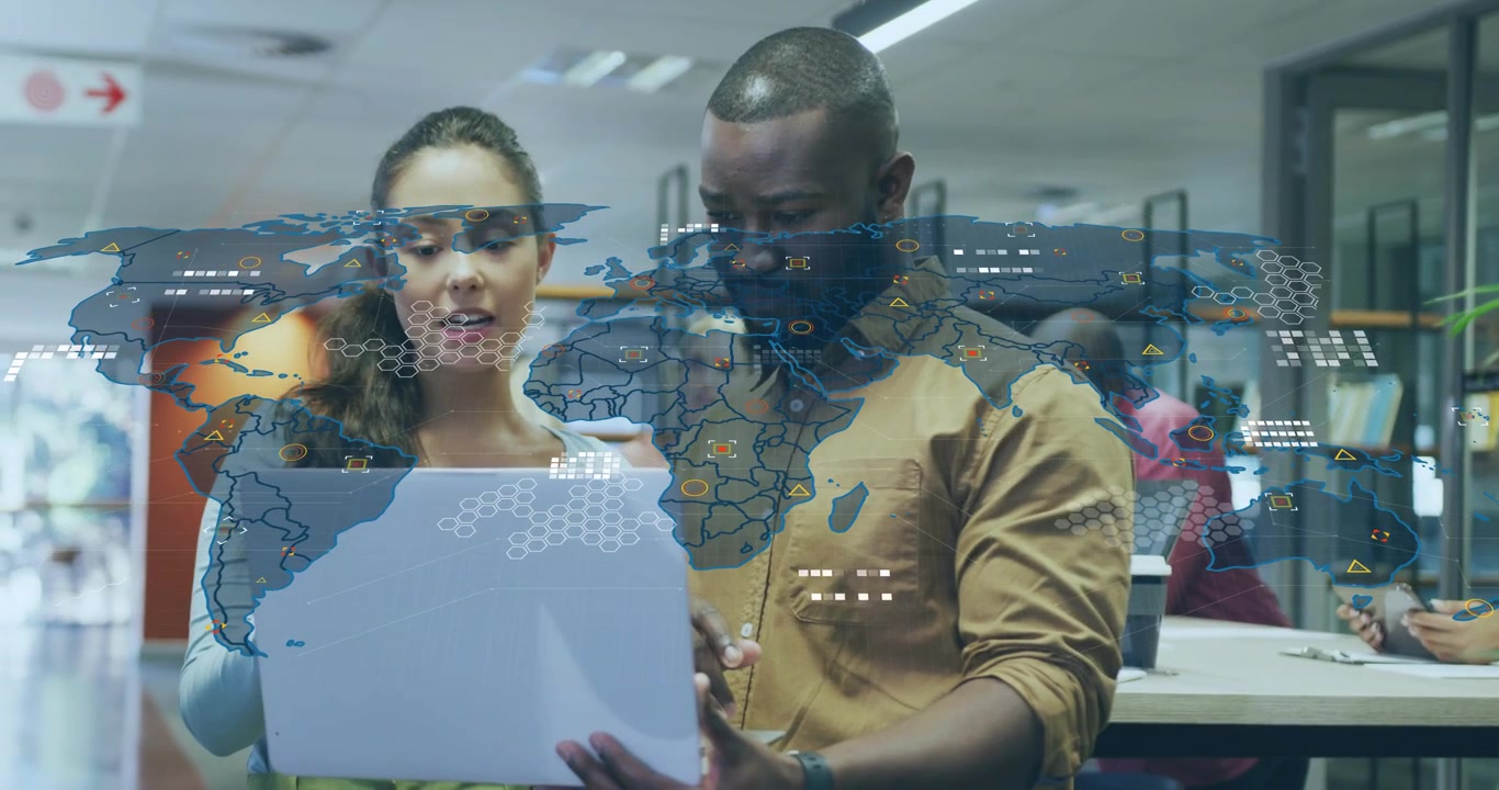 Business colleagues tapping and pointing tablet creating animated world map overlay with data icons