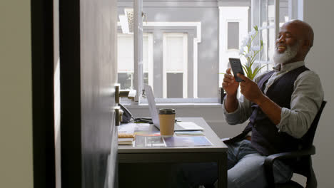 businessman using mobile phone on desk 4k