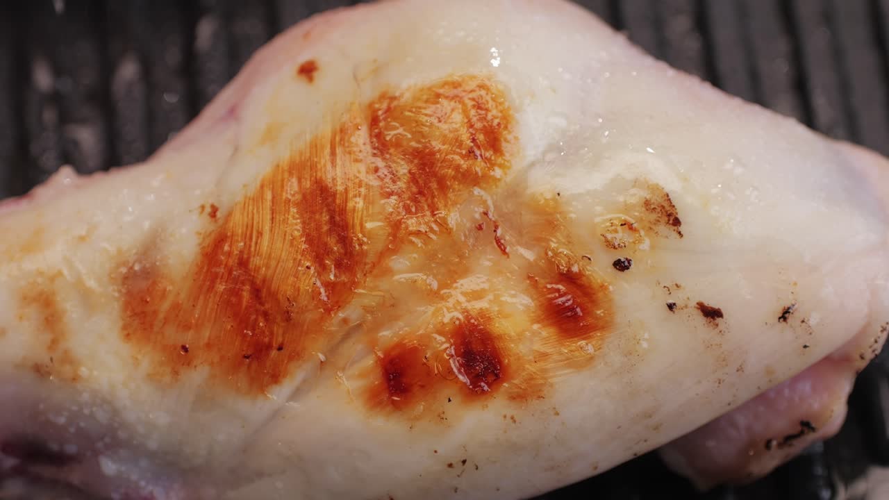 Roasted rabbit legs in a grill pan, healthy diet meat close up, chef cooking rabbit on kitchen restaurant, Black background. Top view