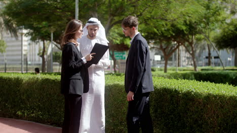 three people talking about business