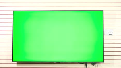 tv with green screen mock up against wall