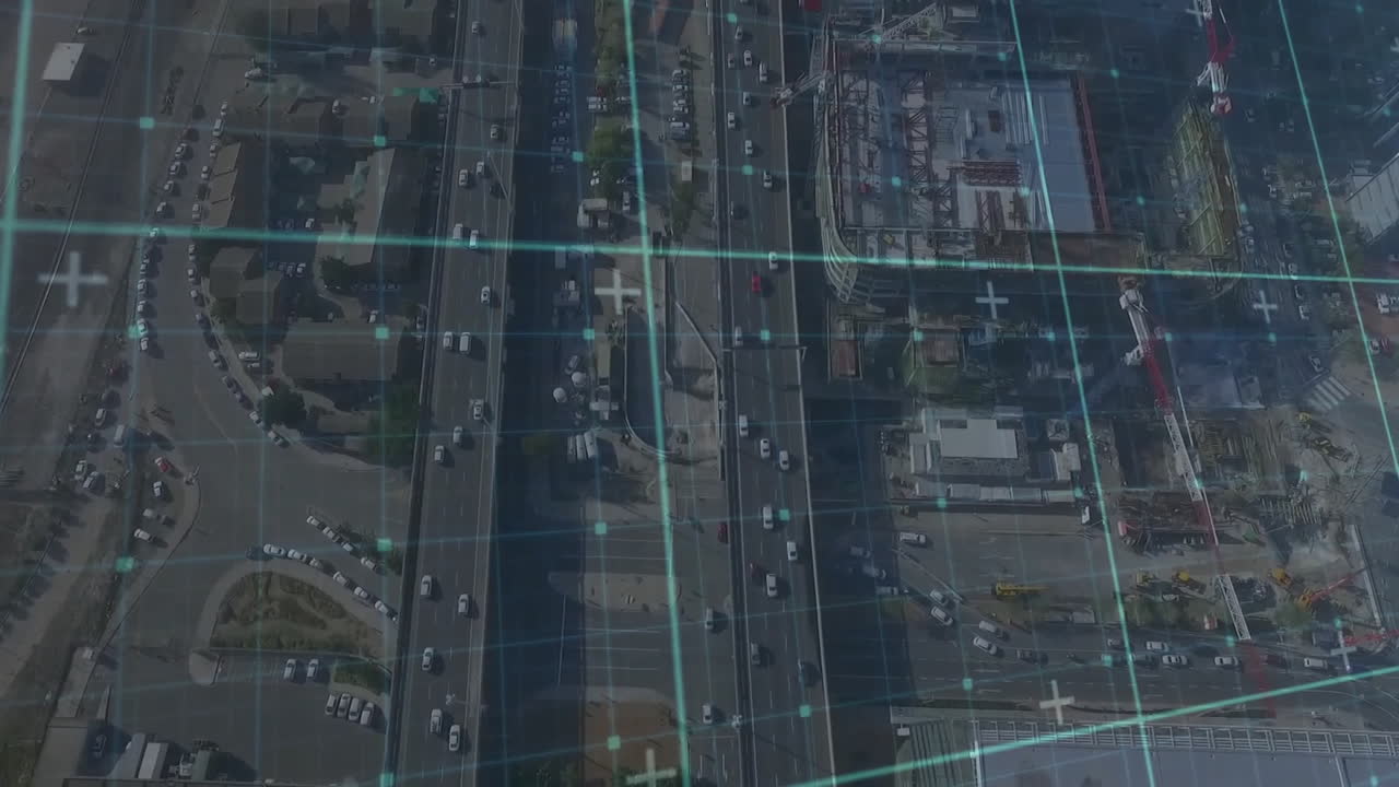 Multi-lane highway and intersection displaying data grid overlay, featuring cars traversing roads