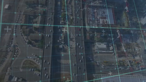 multi-lane highway and intersection displaying data grid overlay, featuring cars traversing roads
