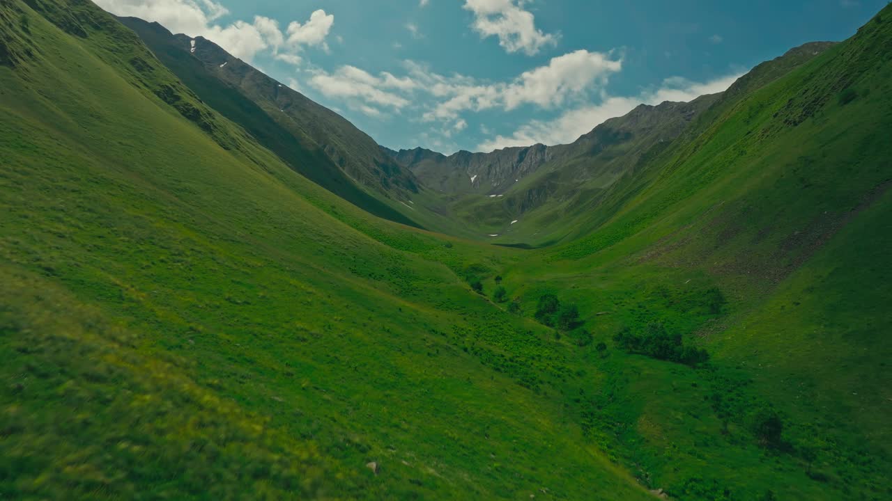 Lush green Juta Valley landscape under blue sky, serene and inspiring view